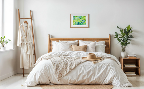Neatly made bed in a bright bedroom with decor elements.